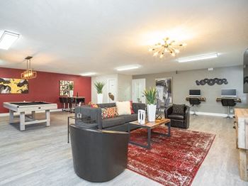 a living room filled with furniture and a pool table